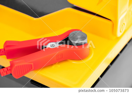 car battery with connected wires on charge 105073873