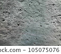 Texture of a light gray concrete wall with holes, strokes, granules, scratches and scuffs. For design and decoration. Photo 105075076