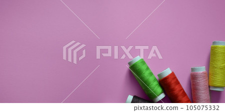 spools of thread on a pink background, a banner for an atelier, tailoring, a photo for a sewing workshop, sewing threads, a place for text spools of thread on a pink background, a banner for an atelier, tailoring, a photo for a sewing workshop, sewing threads, a place for text 105075332