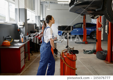 Woman mechanic pushing device for receiving used car engine oil 105076777