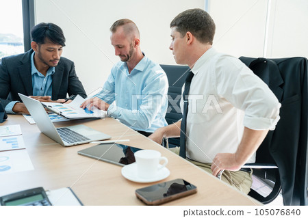 startup business, business advisor explaining strategy for planning finance investment teamwork paperwork audit and discussing marketing, profit, budget of company in meeting room 105076840