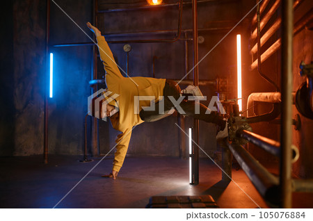 Modern hip hop dancer frozen in movie standing on one hand 105076884