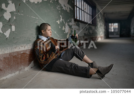 Punk female beggar suffering from nicotine and alcohol addiction 105077044