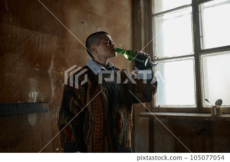 Lonely teenager girl drinking beer having alcohol addiction 105077054