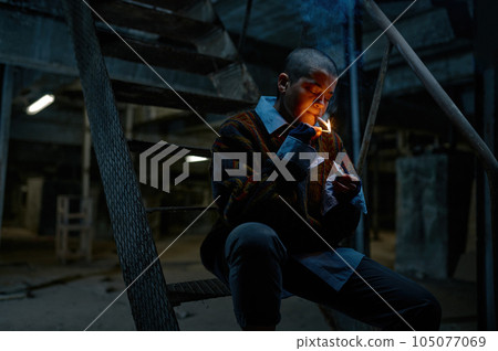 Lonely helpless unemployed teenager girl lighting cigarette 105077069