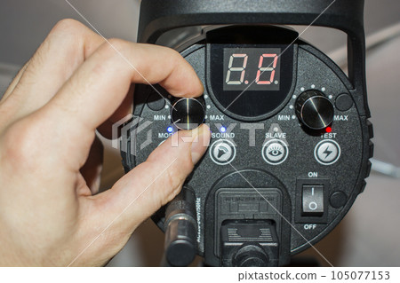 Hand adjusts the flash light of the candy bar Hand adjusts the flash light of the candy bar 105077153