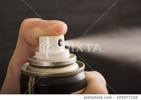 Close-up view of human hand and spray bottle isolated on black 105077188