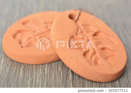 Clay earrings on wooden background Clay earrings on wooden background 105077311