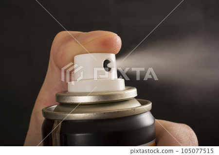 Close-up view of human hand and spray bottle isolated on black 105077515