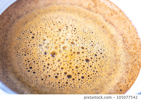 foaming coffee on top 105077542