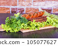 Traditional Caucasian dish. On a cutting board, with green salad, ketchup, spices. 105077627