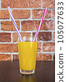 Orange juice Two straws Vitamins Health concept wooden background and brick wall 105077633