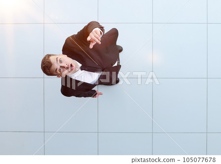 Celebrating success. Low angle view of excited young businessman keeping arms Celebrating success. Low angle view of excited young businessman keeping arms 105077678