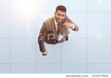 Handsome smiling business man in a suit standing with his arms crossed. 105077683