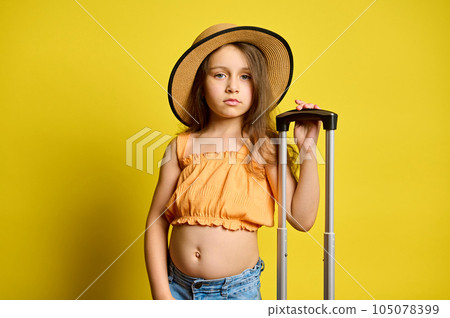 Kid girl with trendy suitcase, travelling abroad for summer holidays. Travel and booking agency. Trip Journey Air flight Kid girl with trendy suitcase, travelling abroad for summer holidays. Travel and booking agency. Trip Journey Air flight 105078399