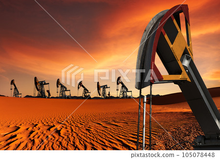 Oil pumps in desert at sunset 105078448