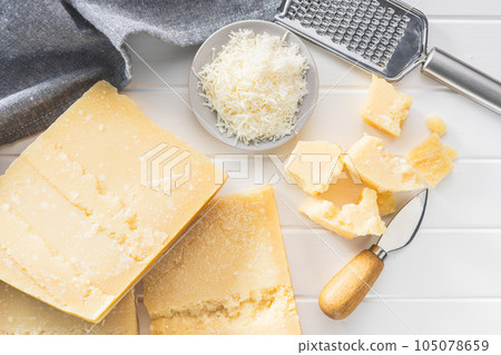 Tasty parmesan cheese on white table. 105078659