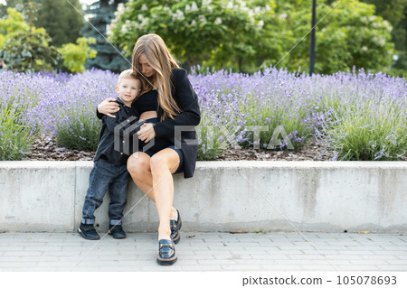Pregnant mother and her little son spending time together in the park, hugging and smiling Pregnant mother and her little son spending time together in the park, hugging and smiling 105078693
