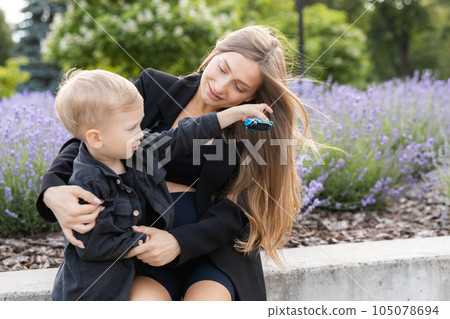 Pregnant mother and her little son spending time together in the park, hugging and smiling Pregnant mother and her little son spending time together in the park, hugging and smiling 105078694