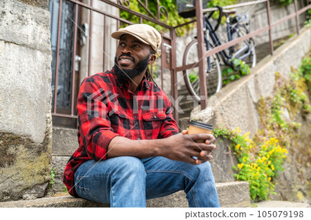 Young handsome african american man in red shirt looking good 105079198