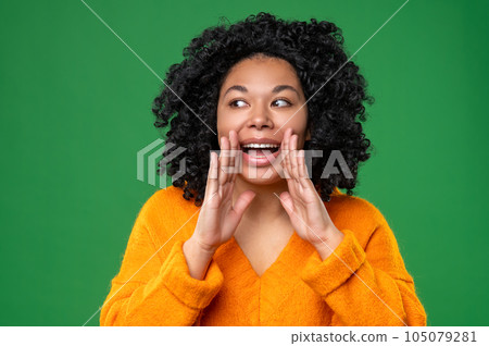 Dark-haired woman in orange calling someone 105079281