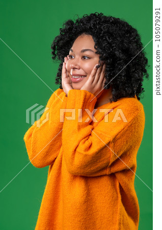 Happy dark-haired ypung woman in orange Happy dark-haired ypung woman in orange 105079291