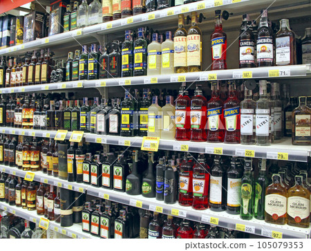 Cognacs, vodka, liqueurs, and other alcoholic beverages on supermarket shelves Cognacs, vodka, liqueurs, and other alcoholic beverages on supermarket shelves 105079353