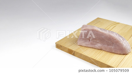 Raw pork shoulder on a wooden meat cutting board Raw pork shoulder on a wooden meat cutting board 105079509
