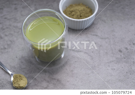 Closeup Glass Of Smoothie, Juice With Hemp Protein Powder On Table. Bowl And Spoon With Plant-derived Protein from Cannabis Plant. Superfood, Healthy Lifestyle. Horizontal Plane, Copy Space For Text. Closeup Glass Of Smoothie, Juice With Hemp Protein Powder On Table. Bowl And Spoon With Plant-derived Protein from Cannabis Plant. Superfood, Healthy Lifestyle. Horizontal Plane, Copy Space For Text. 105079724