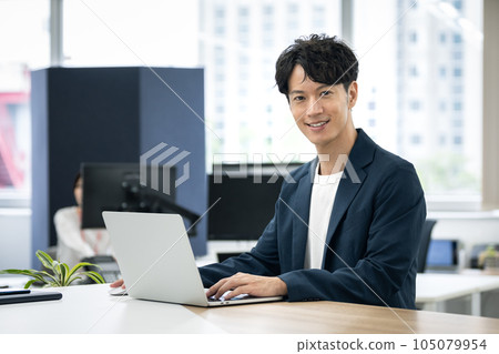 Young businessman at a laptop Young businessman at a laptop 105079954