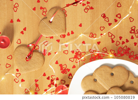 Garland of heart ginger cookies on red ribbon. Valentines Day background. Garland of heart ginger cookies on red ribbon. Valentines Day background. 105080819