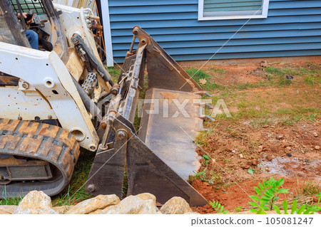 Performing landscaping works moving ground in bulldozer are of project 105081247