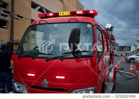 Fire truck extinguishing fire during fire Fire truck extinguishing fire during fire 105082490