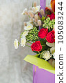 beautiful bright bouquet in a purple basket on a white background, copy space 105083244