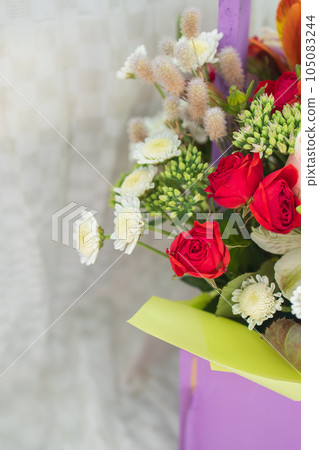 beautiful bright bouquet in a purple basket on a white background, copy space beautiful bright bouquet in a purple basket on a white background, copy space 105083244