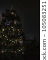Decorated Christmas tree with lights on a dark background, copy space 105083251