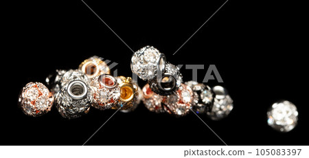 Fashion Silver gold bead ball with beautiful work detail is value. Luxury silver copper metal bead sequin ball is fashion trend and fly in air. Black background isolated selective focus blur Fashion Silver gold bead ball with beautiful work detail is value. Luxury silver copper metal bead sequin ball is fashion trend and fly in air. Black background isolated selective focus blur 105083397