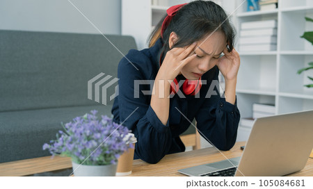 Asian student young woman stress while study on laptop, Asian young woman had headache while study 105084681