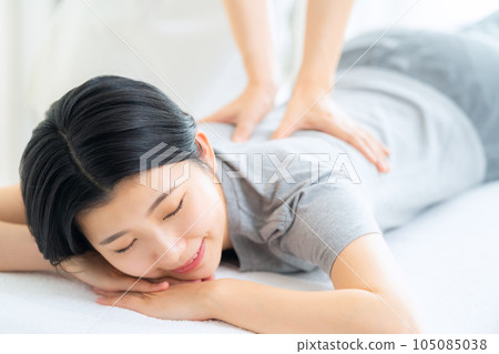 A young woman who receives a manipulative treatment at an osteopathic clinic A young woman who receives a manipulative treatment at an osteopathic clinic 105085038