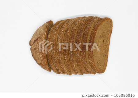 Sliced black bread. Dark rye bread with cumin cut into even pieces on a white background. Wheat black bread on the table. Isolated. Bran from grain. Healthy food. Vegetarian food. Ecological friendly Sliced black bread. Dark rye bread with cumin cut into even pieces on a white background. Wheat black bread on the table. Isolated. Bran from grain. Healthy food. Vegetarian food. Ecological friendly 105086016