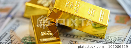 Gold bars on US dollars banknotes background. 105086529