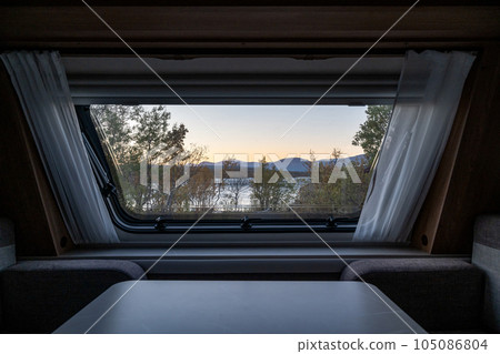 Sunset Autumn season in Abisko through a caravan window with Lake Tornetraesk in background Swedish Lapland Sweden Sunset Autumn season in Abisko through a caravan window with Lake Tornetraesk in background Swedish Lapland Sweden 105086804