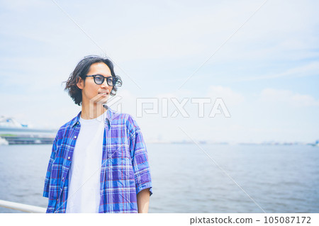 Portrait of a man feeling the sea breeze under the summer sky 105087172