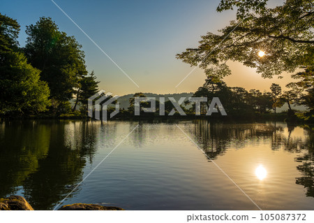 黎明時分的兼六園霞池，清晨的陽光照射進來，形成美麗的水鏡景觀｜石川縣金澤市 105087372