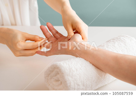 Woman doing hand massage Woman doing hand massage 105087559