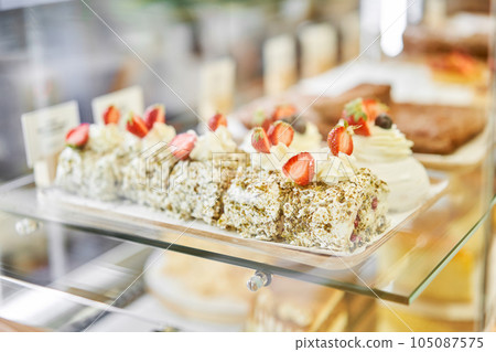 fresh pastries with berries. A variety of fresh pastries in the bakery window. almond croissant is fresh and hot in a cafe next to other types of pastries. The interior of an Italian restaurant. 105087575