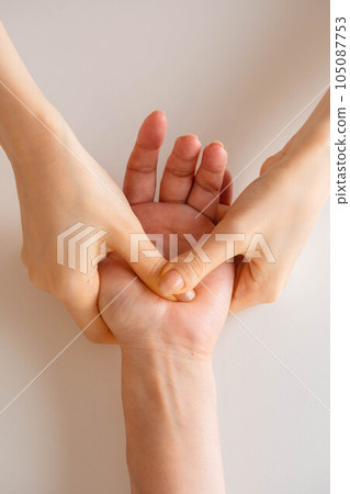 Woman doing hand massage Woman doing hand massage 105087753