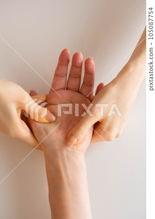 Woman doing hand massage Woman doing hand massage 105087754