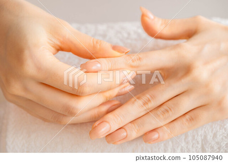 Woman doing self-care hand massage Woman doing self-care hand massage 105087940