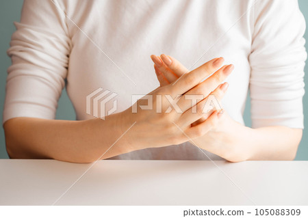 Woman massaging her hands on her chest 105088309